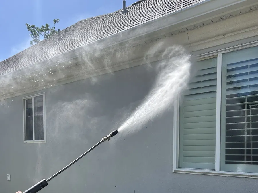 Washing a roofline, gutter and soffit on a stucco home