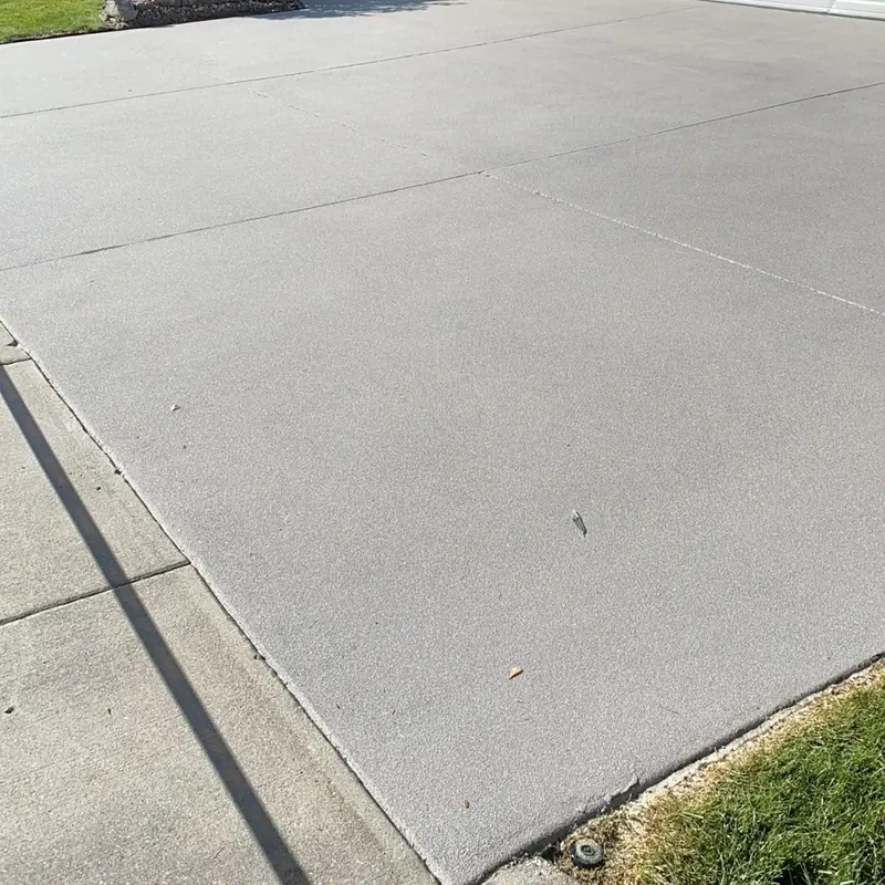 Clean concrete driveway with crisp control joints